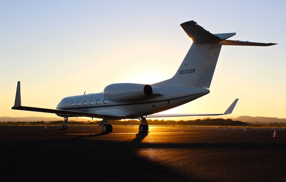 A Private Jet Charter Parked at a US Airport During Sunset