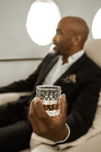 a passenger holding a whiskey glass