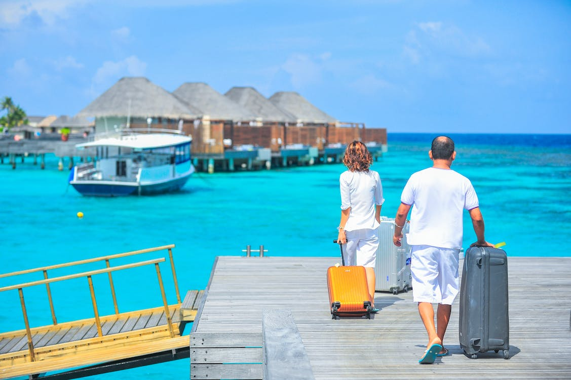 a couple arriving at a beach on a private jet charter flight
