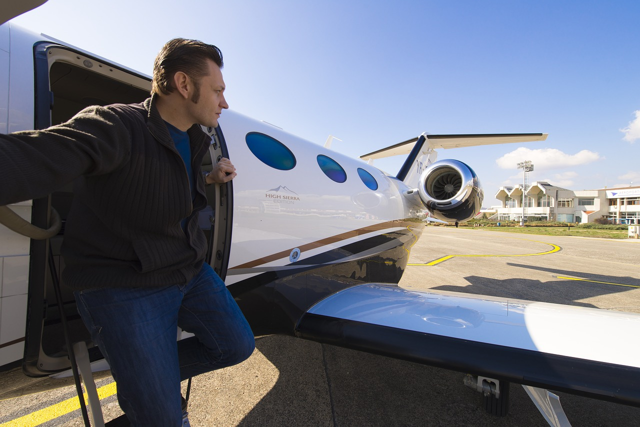 a man climbing out of a private jet charter flight